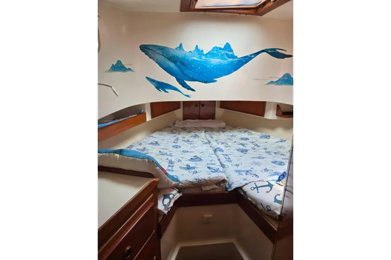 Slide: The Image of Cozy cabin interior of 1987 Transpacific Marine Eagle 32 with whale mural and nautical bedding. - 10
