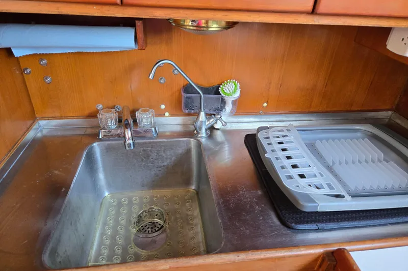 Slide: The Image of Galley sink area in 1987 Transpacific Marine Eagle 32 boat with dish rack and faucet. - 13
