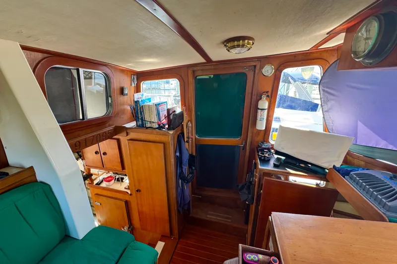 Slide: The Image of Interior of 1987 Transpacific Marine Eagle 32 boat with wooden cabinetry and green seating. - 16