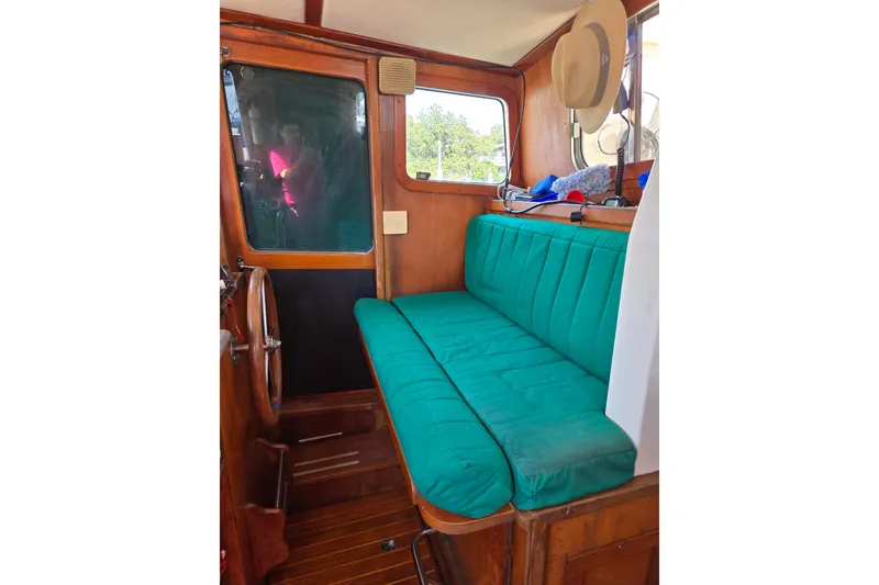 Slide: The Image of Interior of 1987 Transpacific Marine Eagle 32 with green cushioned seating and wooden accents. - 17