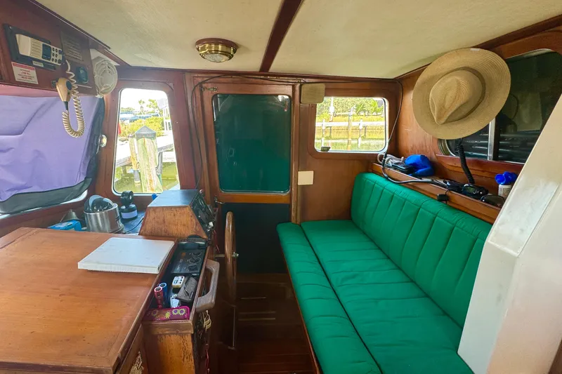 Slide: The Image of Interior of 1987 Transpacific Marine Eagle 32 with green seating and wooden accents. - 18
