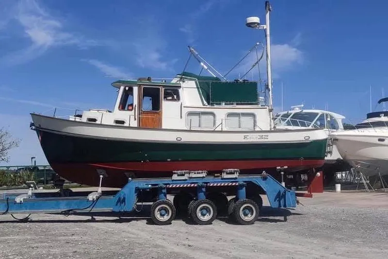 Slide: The Image of 1987 Transpacific Marine Eagle 32 boat on trailer under clear blue sky. - 2