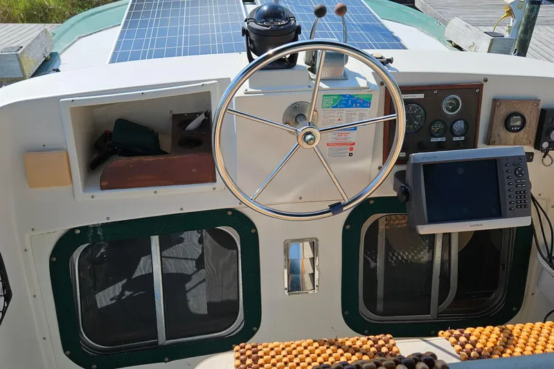 Slide: The Image of Helm of 1987 Transpacific Marine Eagle 32 with navigation equipment and solar panels. - 25