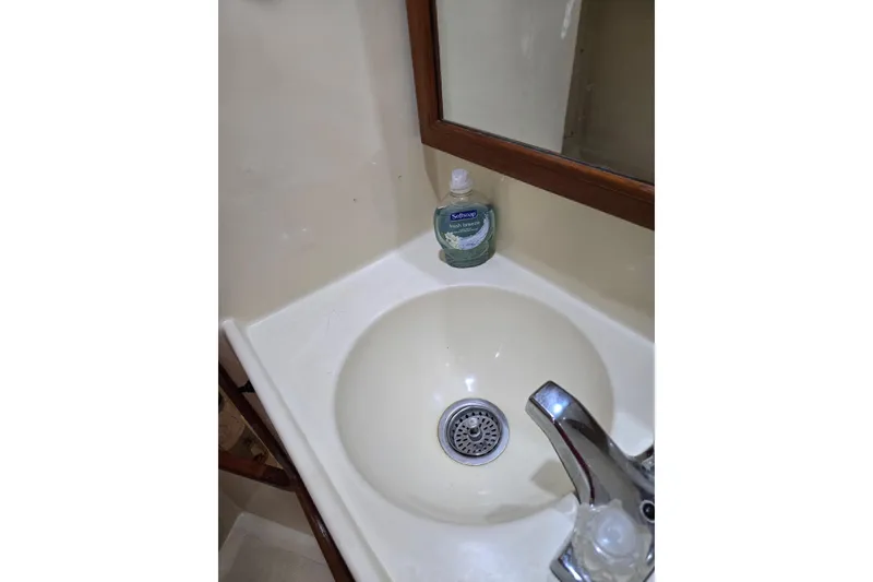 Slide: The Image of Small bathroom sink with faucet and soap in 1987 Transpacific Marine Eagle 32. - 28