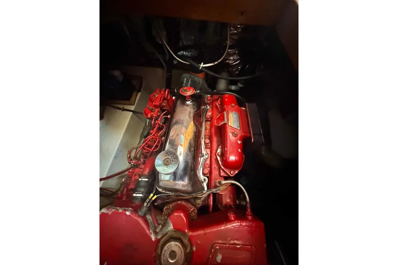 Slide: The Image of Engine of 1987 Transpacific Marine Eagle 32, featuring red components and metallic details. - 34