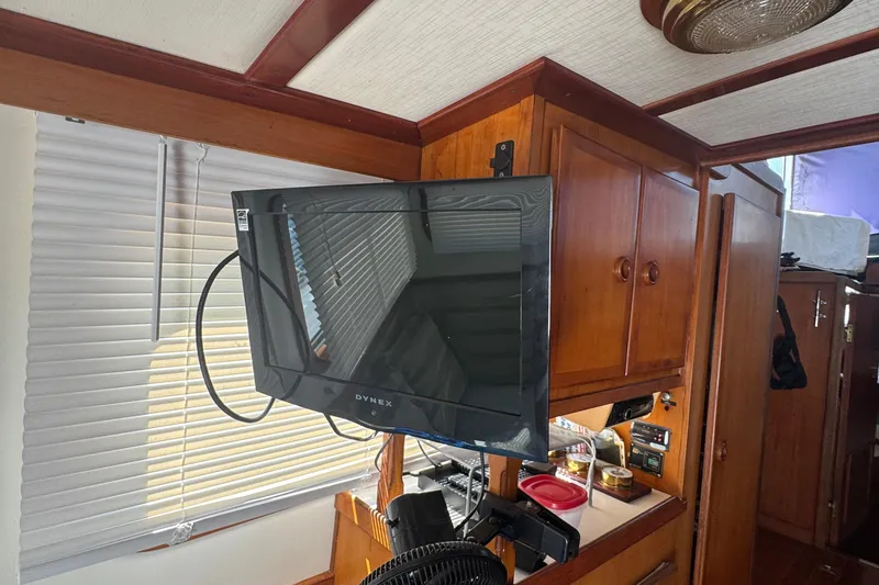 Slide: The Image of Interior of 1987 Transpacific Marine Eagle 32 with mounted Dynex TV and wooden cabinetry. - 35