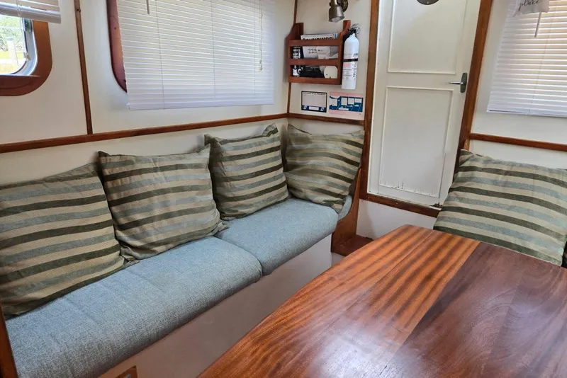 Slide: The Image of Interior of 1987 Transpacific Marine Eagle 32 with striped cushions and wooden table. - 6