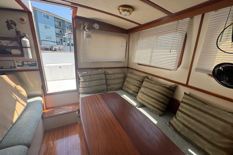Slide: The Image of Interior of 1987 Transpacific Marine Eagle 32 with cozy seating and striped cushions. - 7