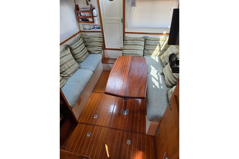 Slide: The Image of Interior of 1987 Transpacific Marine Eagle 32 with wooden table and striped cushions. - 8