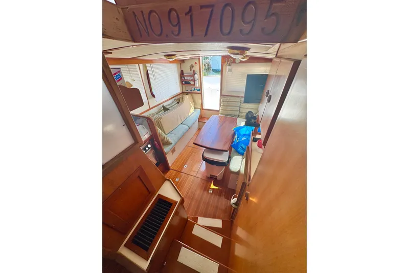 Slide: The Image of Interior of 1987 Transpacific Marine Eagle 32, featuring cozy seating and wooden finishes. - 9