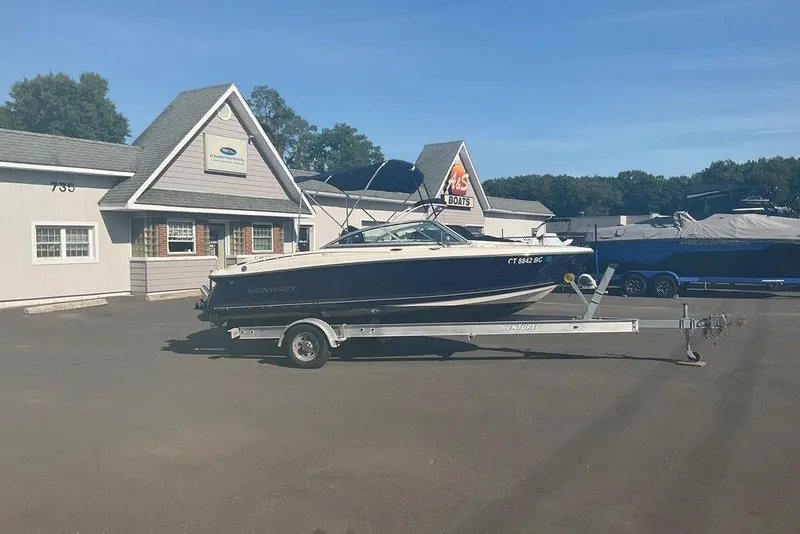 The Image of 2009 Monterey 180 FS boat on trailer outside dealership, clear sky. - 1