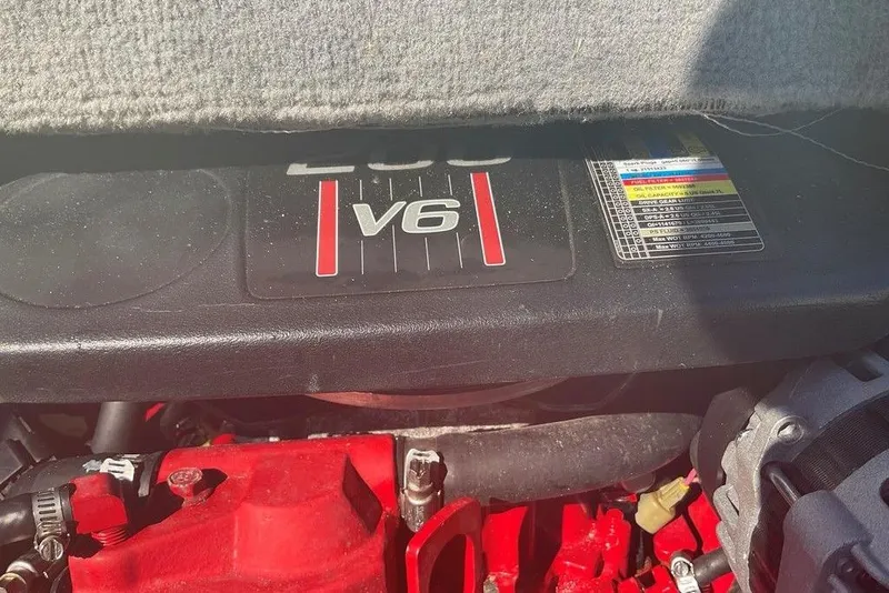 Slide: The Image of 2009 Monterey 180 FS V6 engine close-up with specifications label. - 12