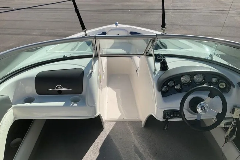 Slide: The Image of 2009 Monterey 180 FS boat interior with steering wheel and dashboard controls. - 13