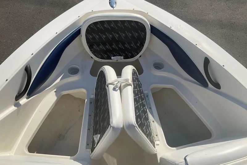 Slide: The Image of 2009 Monterey 180 FS boat interior with cushioned seating and storage compartments. - 16