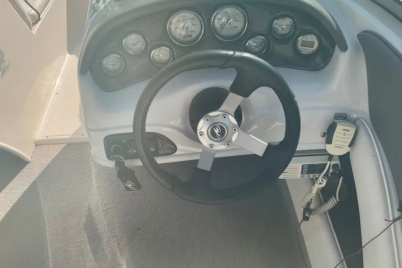 Slide: The Image of Steering wheel and dashboard of a 2009 Monterey 180 FS boat. - 17