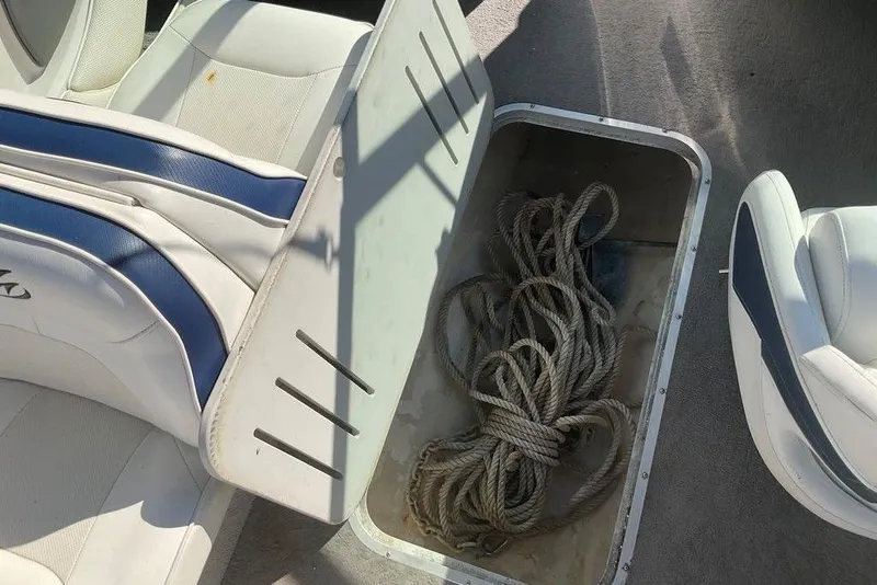 Slide: The Image of Open storage compartment with rope in a 2009 Monterey 180 FS boat interior. - 18