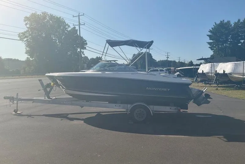 Slide: The Image of 2009 Monterey 180 FS boat on trailer in sunny outdoor setting. - 2