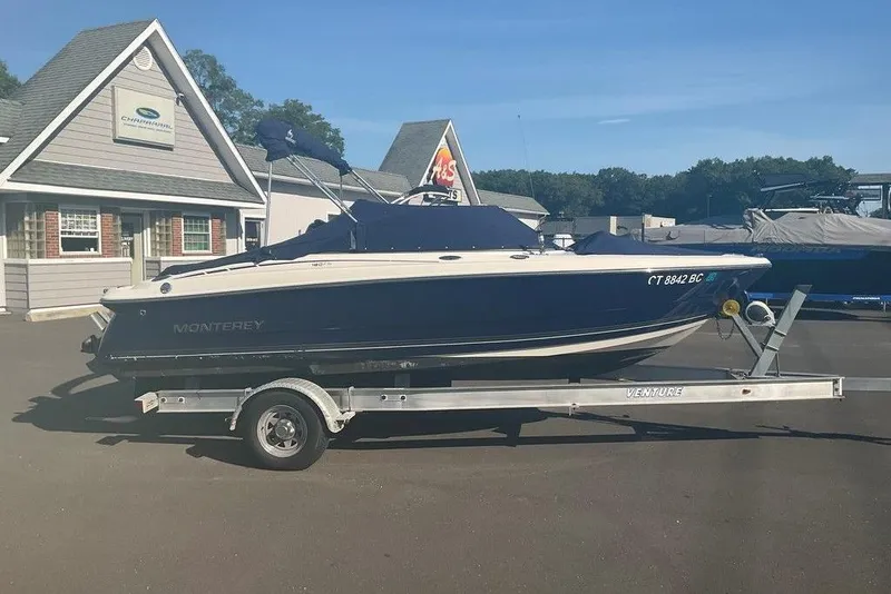 Slide: The Image of 2009 Monterey 180 FS boat on trailer outside dealership. - 21