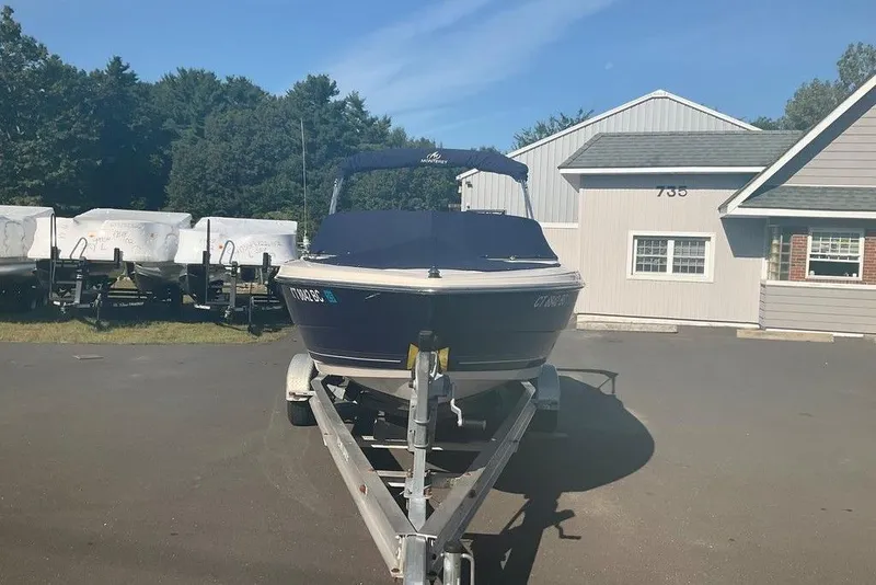 Slide: The Image of 2009 Monterey 180 FS boat on trailer, parked near building and trees. - 22