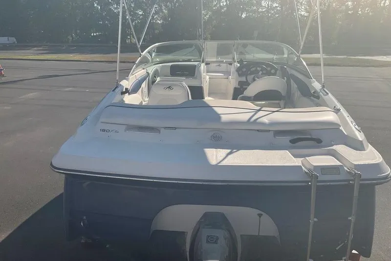 Slide: The Image of 2009 Monterey 180 FS boat, rear view, parked on pavement in sunlight. - 4