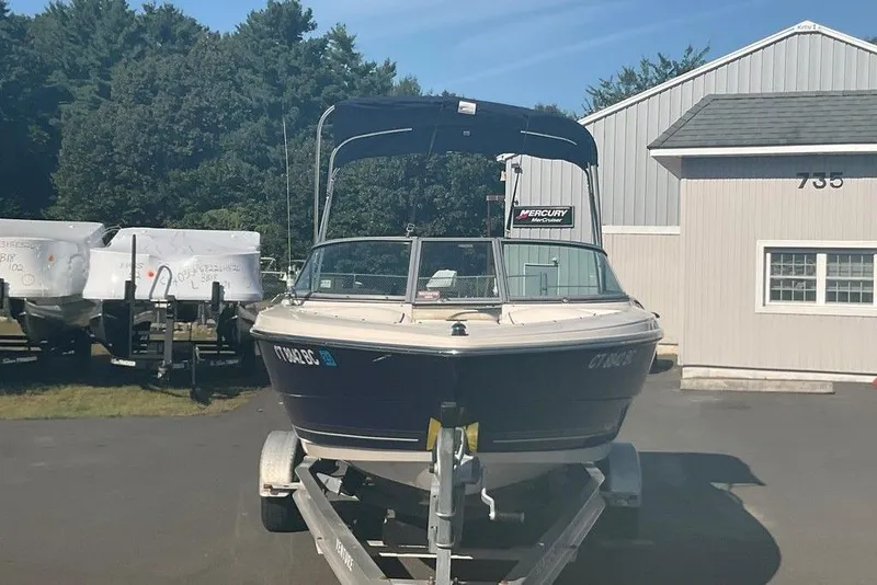 Slide: The Image of 2009 Monterey 180 FS boat on trailer, parked outdoors near a building. - 5