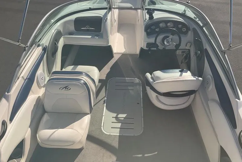 Slide: The Image of Interior of a 2009 Monterey 180 FS boat, featuring seating and steering console. - 6