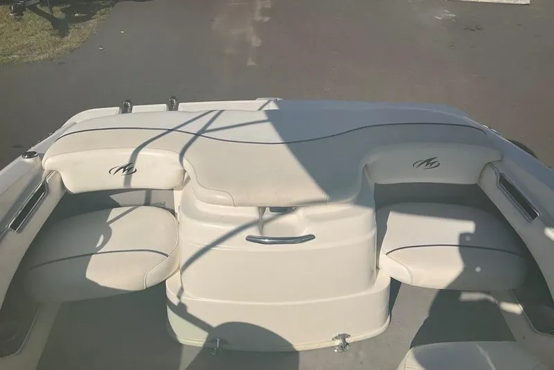 Slide: The Image of 2009 Monterey 180 FS boat interior with white seating and logo. - 9