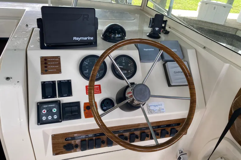 Slide: The Image of Open hatch of 2003 Mainship Pilot 30-II Sedan showing storage compartment and equipment. - 11