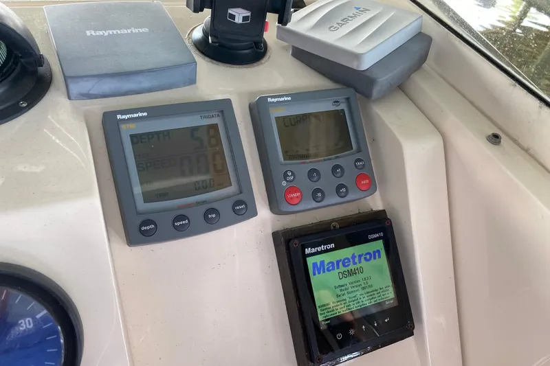 Slide: The Image of Captain's chair on 2003 Mainship Pilot 30-II Sedan boat, featuring light gray upholstery. - 13