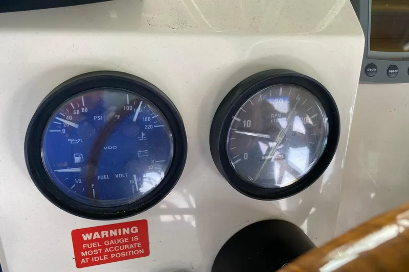 Slide: The Image of 2003 Mainship Pilot 30-II Sedan helm with Raymarine electronics and wooden steering wheel. - 14