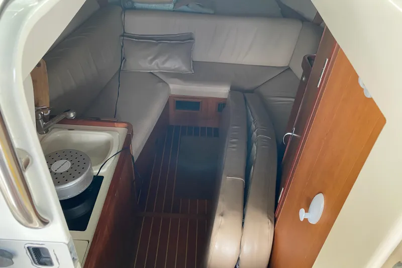 Slide: The Image of Beige cushioned seat on 2003 Mainship Pilot 30-II Sedan boat deck. - 21