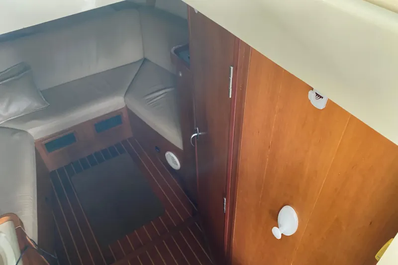 Slide: The Image of Wooden folding table on 2003 Mainship Pilot 30-II Sedan boat interior. - 23