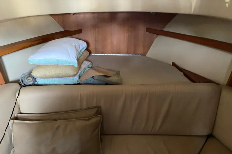 Slide: The Image of 2003 Mainship Pilot 30-II Sedan interior with cozy seating and compact kitchen area. - 24