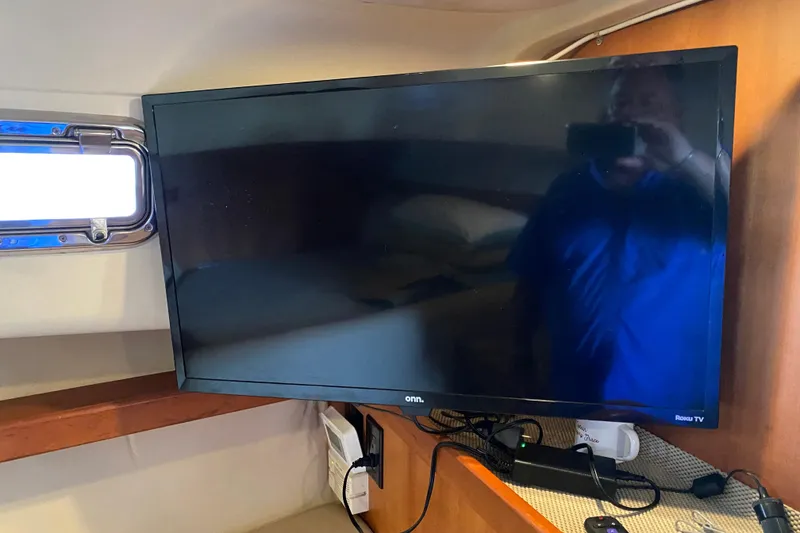 Slide: The Image of 2003 Mainship Pilot 30-II Sedan interior seating with beige cushions and wooden accents. - 29