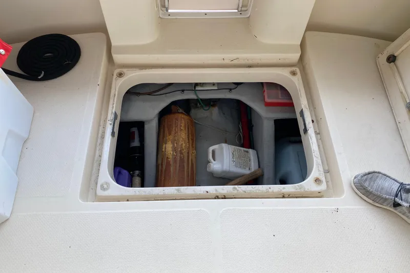 Slide: The Image of 2003 Mainship Pilot 30-II Sedan boat interior with seating and helm under a canopy. - 8