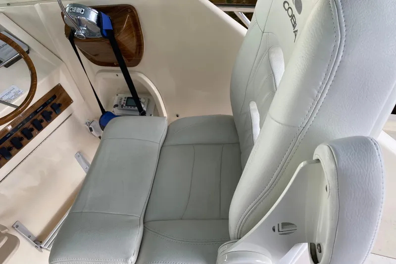 Slide: The Image of 2003 Mainship Pilot 30-II Sedan boat interior with seating and control panel. - 9