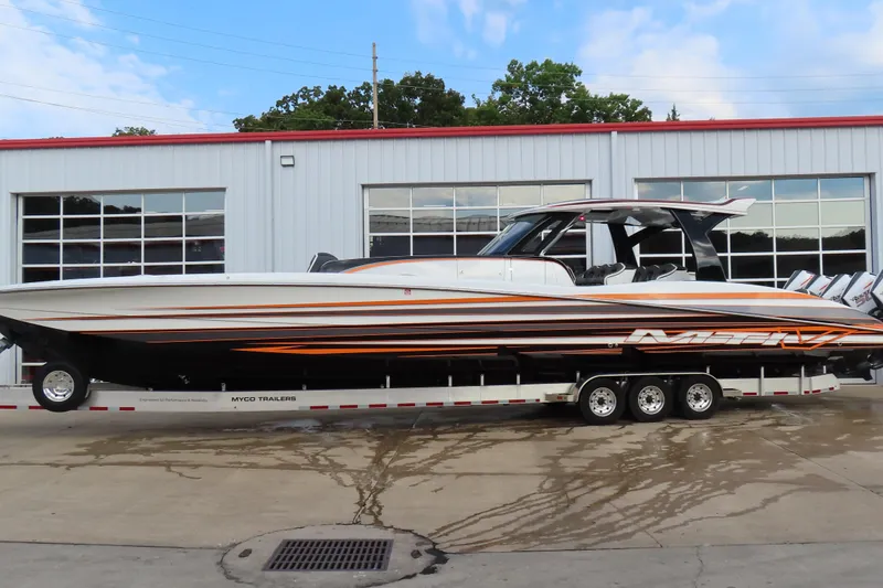 The Image of 2024 MTI 50v powerboat on trailer, sleek design with orange and black accents. - 1
