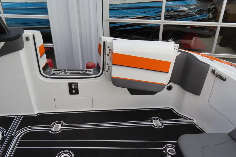 Slide: The Image of 2024 MTI 50v boat interior with orange accents and sleek black flooring. - 10