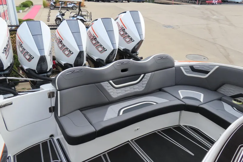 Slide: The Image of 2024 MTI 50v boat with quad engines and sleek seating design. - 11