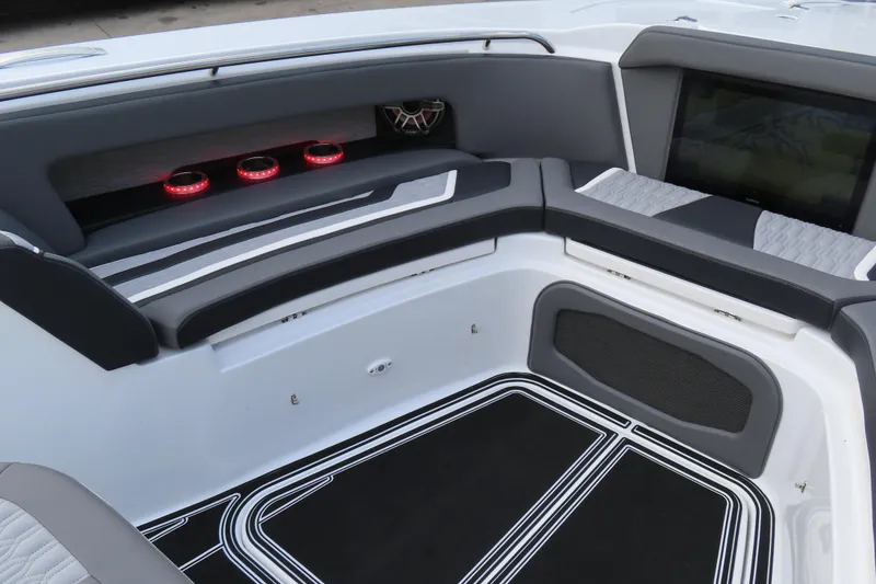 Slide: The Image of 2024 MTI 50v boat interior with sleek seating and illuminated cup holders. - 24