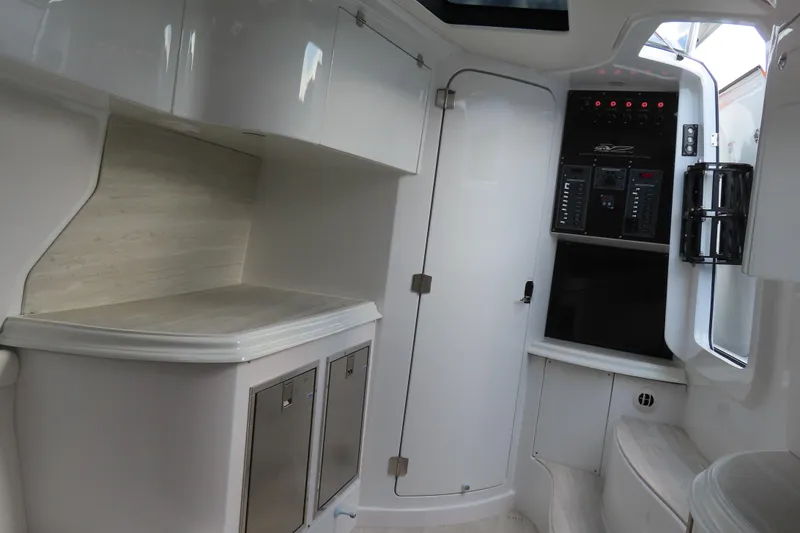 Slide: The Image of 2024 MTI 50v boat interior with sleek cabinetry and control panel. - 27