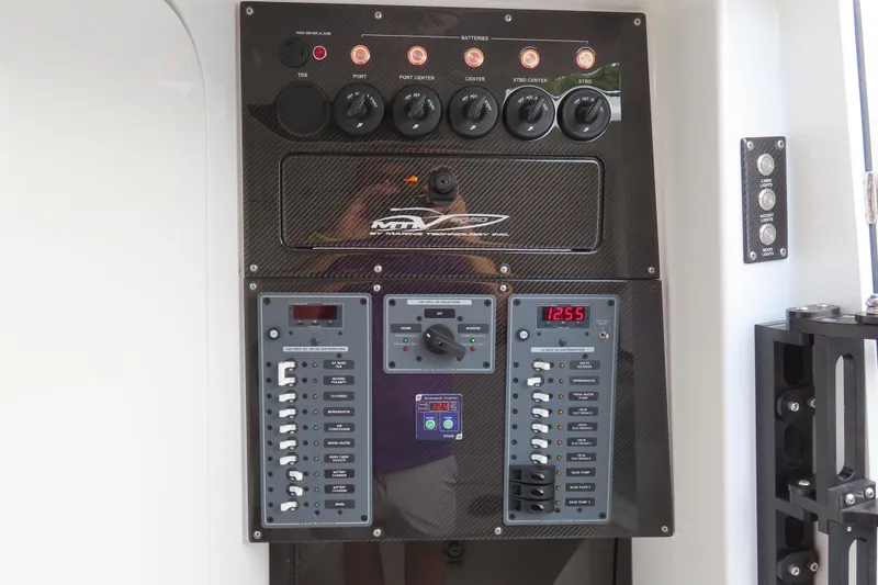 Slide: The Image of Control panel of 2024 MTI 50v boat with carbon fiber finish and digital displays. - 31