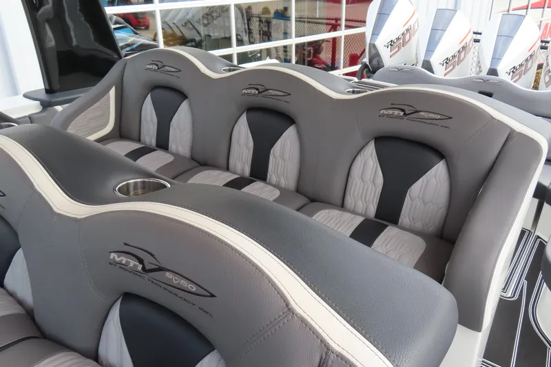 Slide: The Image of 2024 MTI 50v boat interior with luxurious gray seating and cup holder. - 33