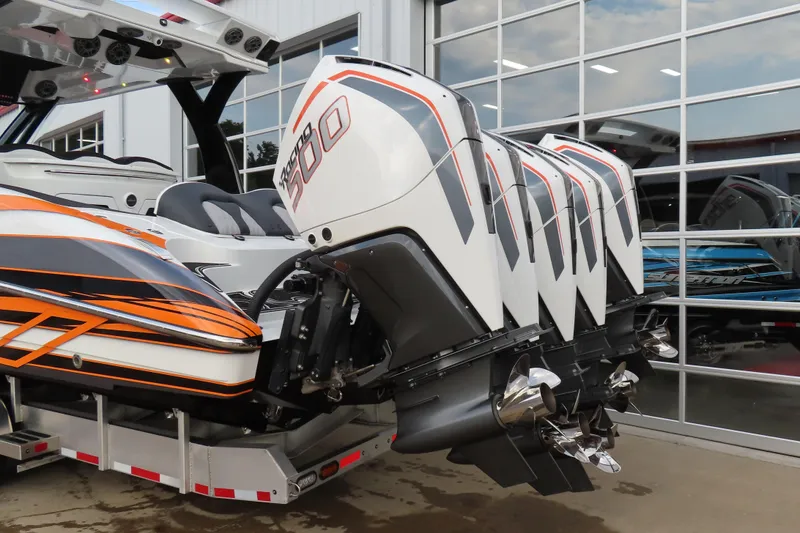 Slide: The Image of 2024 MTI 50v boat with multiple powerful outboard engines, parked near a glass building. - 5