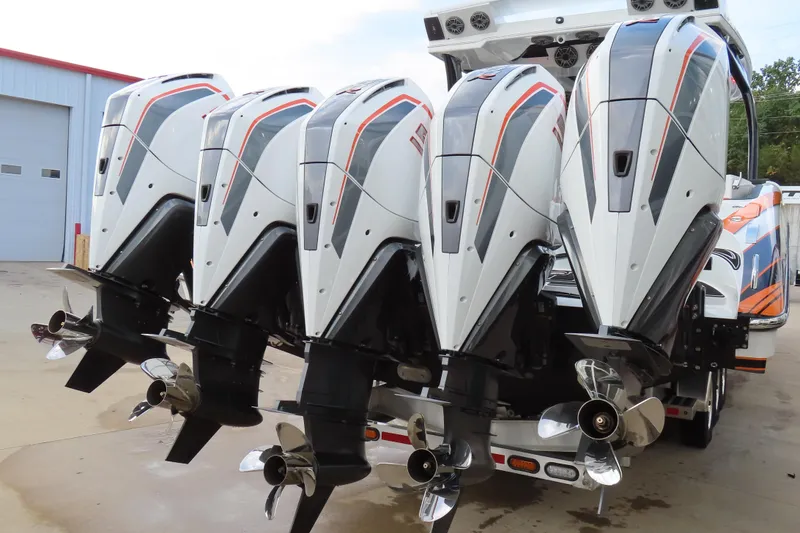 Slide: The Image of Four powerful outboard motors on a 2024 MTI 50v boat, showcasing sleek design and performance. - 6