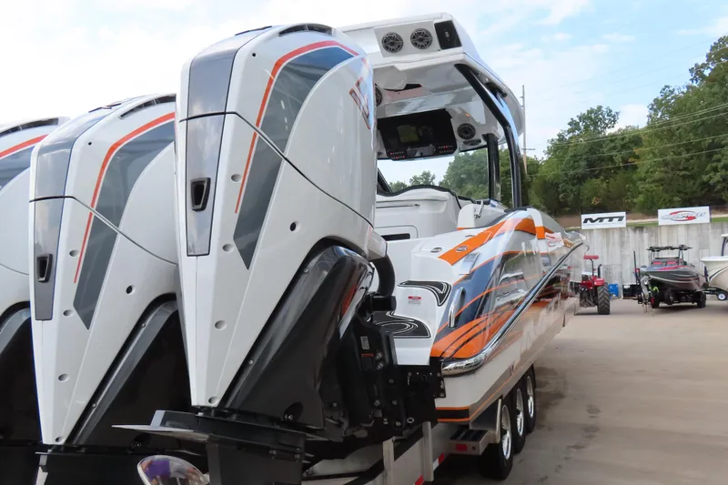 Slide: The Image of 2024 MTI 50v boat with powerful engines, sleek design, and vibrant orange accents. - 7