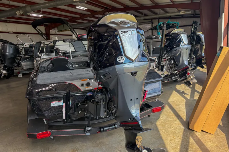 Slide: The Image of 2026 Skeeter ZXE20 boat with powerful outboard motor in showroom. - 13