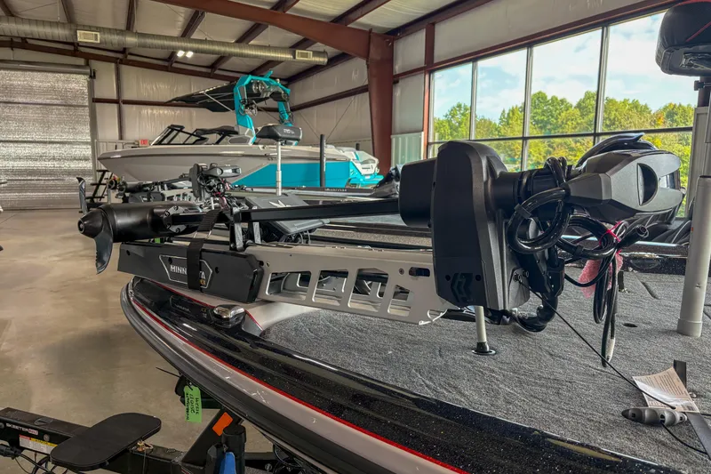 Slide: The Image of 2026 Skeeter ZXE20 boat with Minn Kota trolling motor in a showroom. - 3