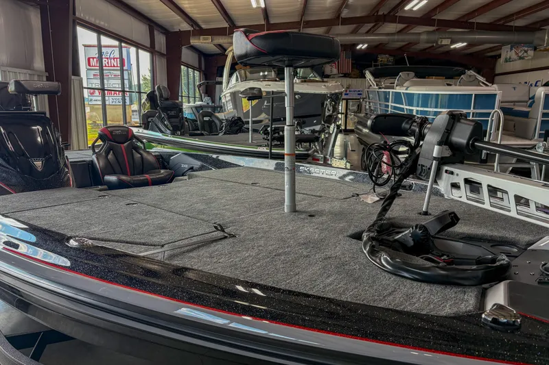 Slide: The Image of 2026 Skeeter ZXE20 boat interior in showroom, featuring seating and equipment. - 6