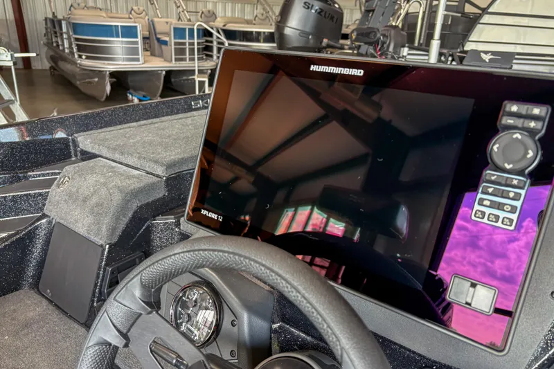 Slide: The Image of 2026 Skeeter ZXE20 boat dashboard with Humminbird Xplore 12 display in a showroom. - 7